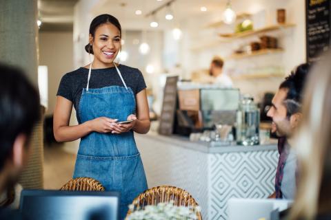 A server in a coffee shop taking an order