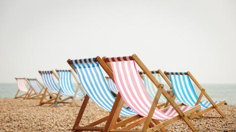 picture of deckchairs on the beach