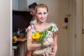 A young woman holding a bag of vegetables