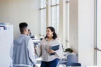 A student talking to an office worker