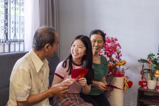 teenager receiving red packets from grandparents