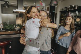 Two young women hugging each other