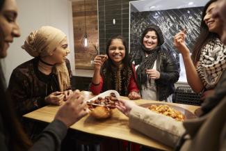 A Muslim family eating dates together 