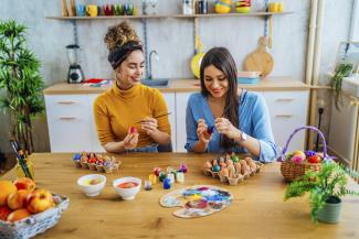young women painting Easter eggs