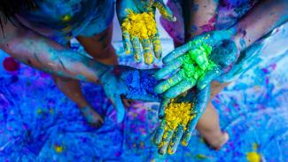 hands covered in coloured powder