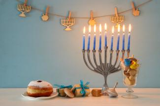 Hanukkah candles, food and items on a table