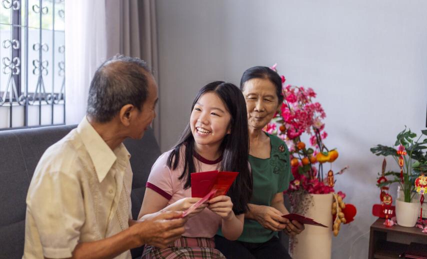 teenager receiving red packets from grandparents