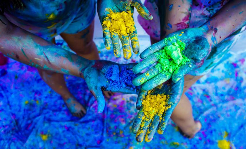 hands covered in coloured powder