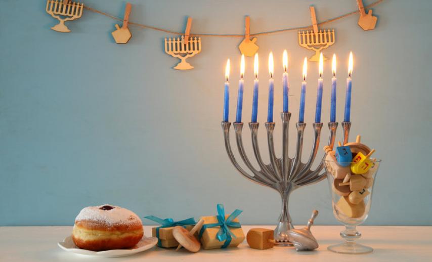 Hanukkah candles, food and items on a table