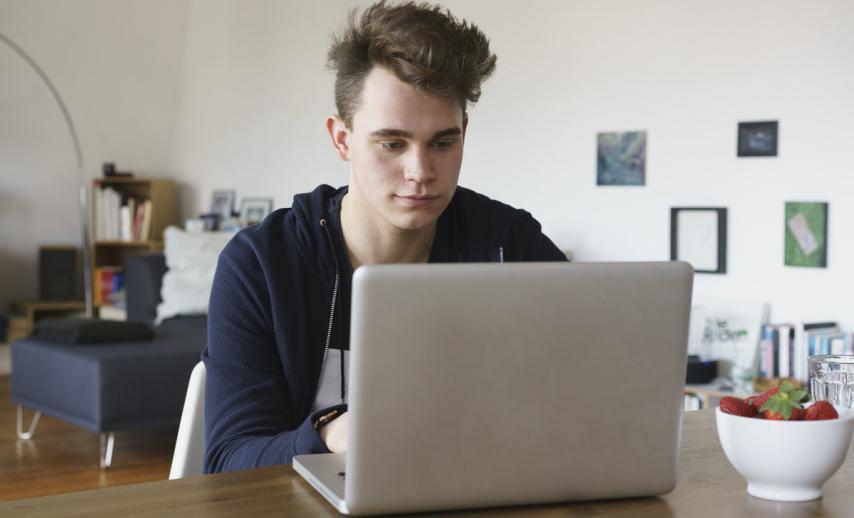A young man using a laptop