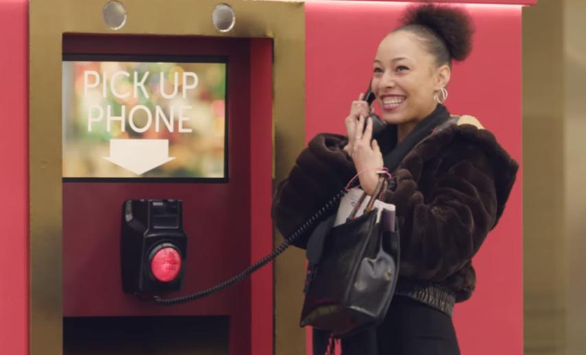 A woman holding a phone and smiling